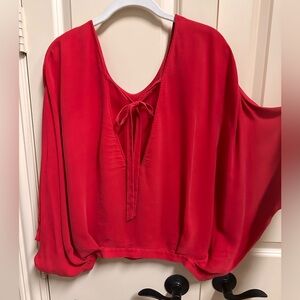 Alice and Olivia silk blouse button side closure at waist. Open back with tie
